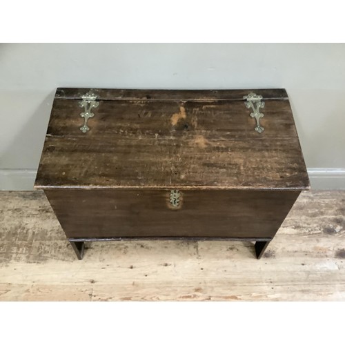 448 - An 18th century boarded chest having a slightly sloped top, with later brass hinges and escutcheon, ... 