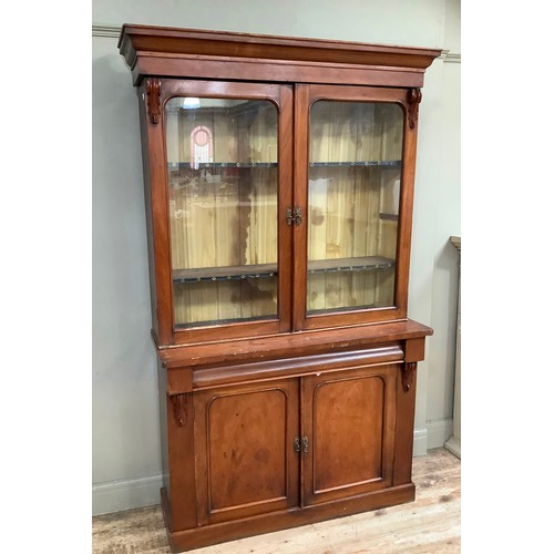 420 - A Victorian mahogany bookcase cupboard having a moulded cornice above two glazed doors, the lower se... 