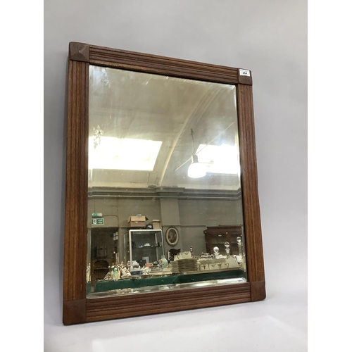 264 - An oak framed wall mirror with bevelled glass, c1910, 72cm by 57cm