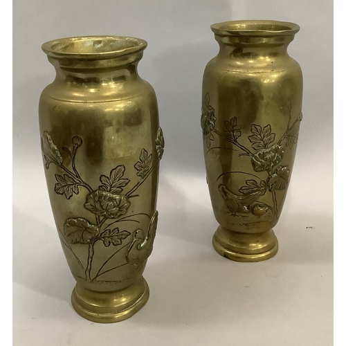 3 - A pair of Japanese brass vases the bodies having moulded and etched decoration with flared rims, 15c... 