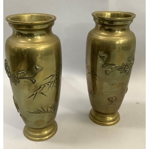 3 - A pair of Japanese brass vases the bodies having moulded and etched decoration with flared rims, 15c... 