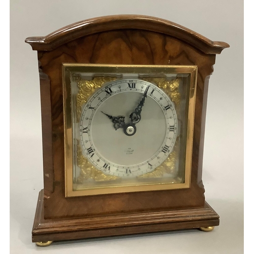 37 - An Elliott mantel clock with silvered and gilt dial, in walnut case on brass bun feet, 18cm high