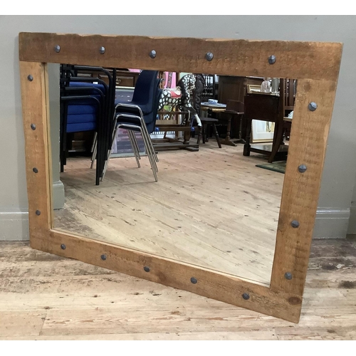 282 - A metal studded pine framed wall mirror, 92.5cm x 118cm