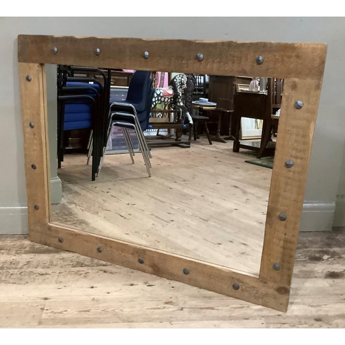 282 - A metal studded pine framed wall mirror, 92.5cm x 118cm