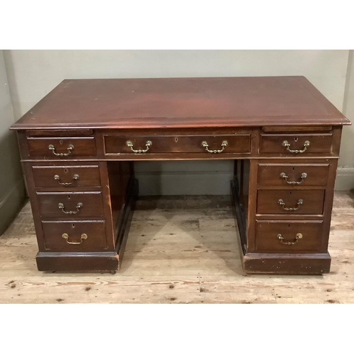 413 - An early 20th century kneehole desk having three drawers across with pull slides and three graduated... 