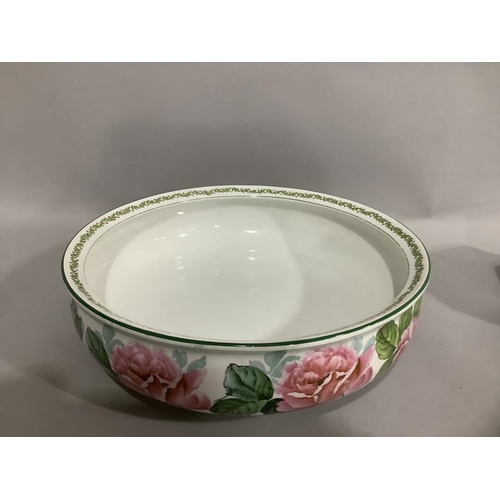 48 - A Crescent china toilet bowl printed and painted with a continuous band of roses, 38cm diameter