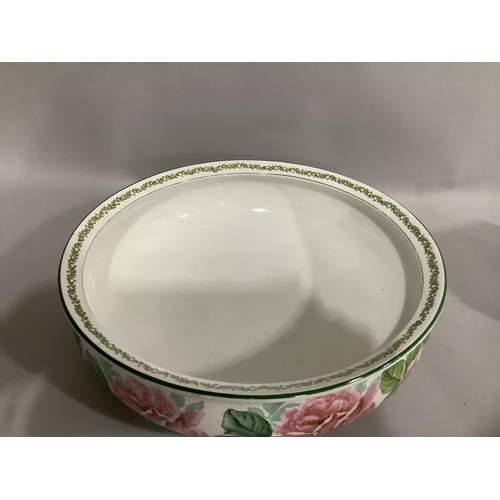 48 - A Crescent china toilet bowl printed and painted with a continuous band of roses, 38cm diameter