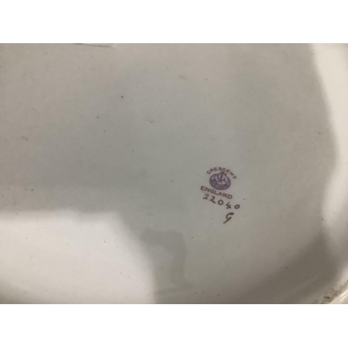 48 - A Crescent china toilet bowl printed and painted with a continuous band of roses, 38cm diameter