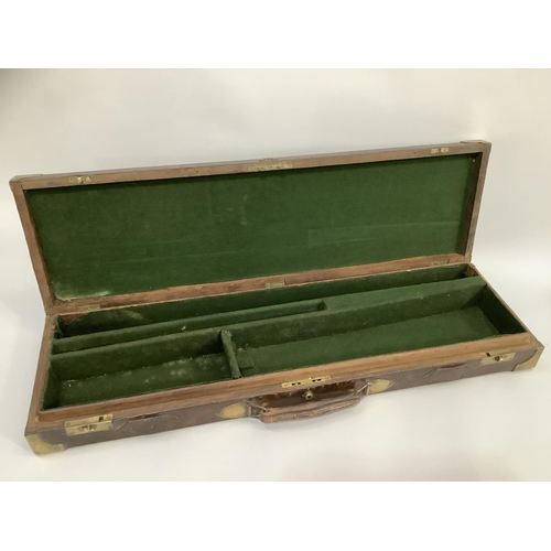 99 - A late 19th century gun case for a double barrelled twelve bore shot gun in leather clad oak with br... 