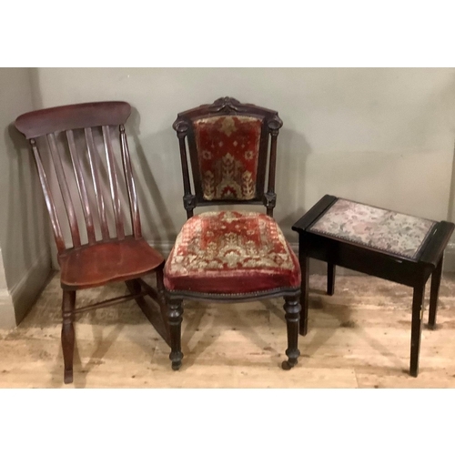 79 - A late Victorian/Edwardian rail back rocking chair on turned supports together with a Victorian ebon... 