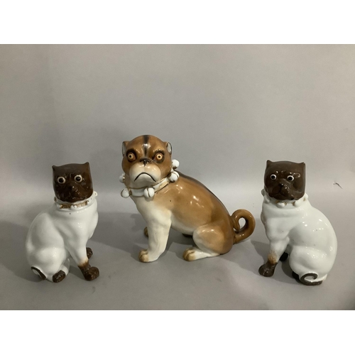 10 - Three 19th century continental Dresden style porcelain figures of pugs having collars with bells, la... 