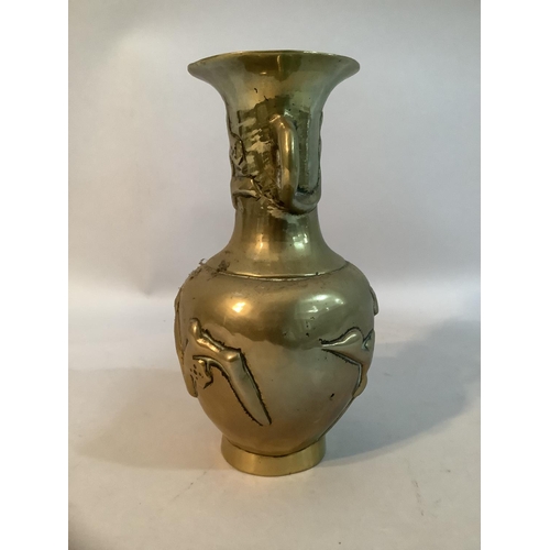 11 - A Japanese brass vase with twin handles to the neck, decorated in relief with prunus blossom, 9cm hi... 