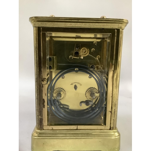 20 - A brass French carriage clock having a white dial with Roman numerals and Arabic chapter ring, visib... 
