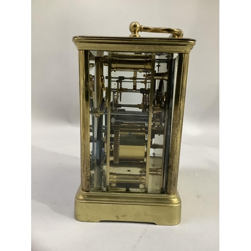 20 - A brass French carriage clock having a white dial with Roman numerals and Arabic chapter ring, visib... 
