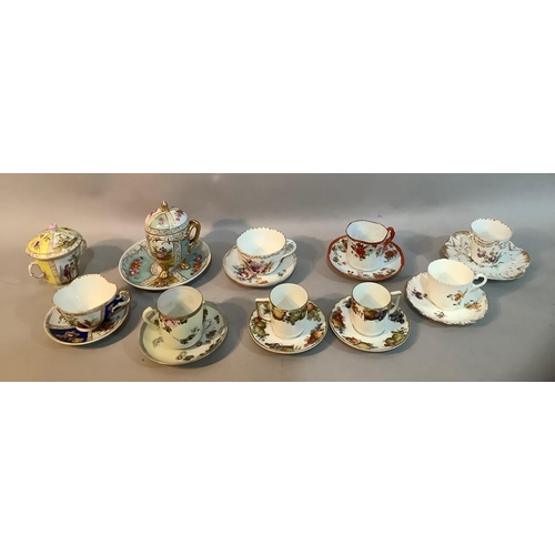 5 - A collection of continental porcelain cabinet cups and saucers, comprising Meissen cup and cover wit... 