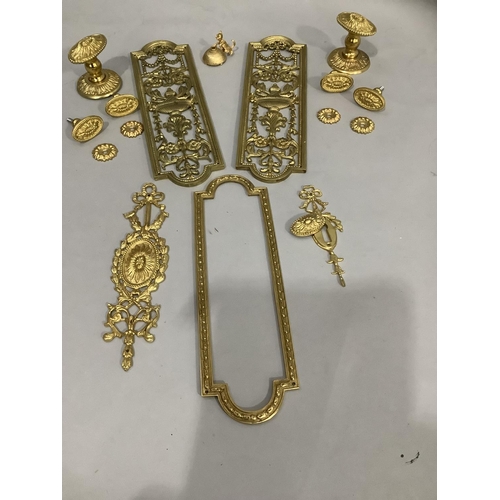 181 - Two brass door plates having central pierced decoration together with door handles / knobs and other... 