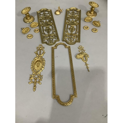 181 - Two brass door plates having central pierced decoration together with door handles / knobs and other... 