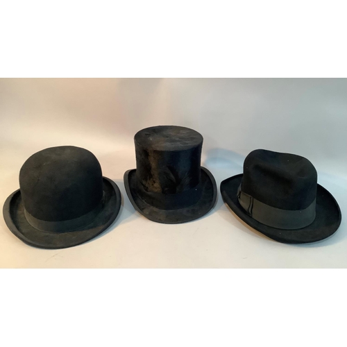 203 - A black bowler hat by Moores and another by G A Dunn, London together with a black top hat with feat... 