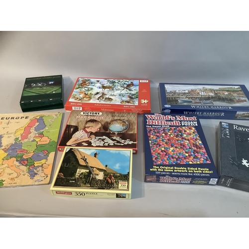 125 - A collection of vintage and unopened jigsaw puzzles including The World's Most Difficult Jigsaw