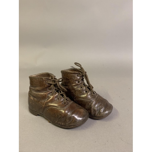 57B - Victorian boots for young children: a pair of brown leather ankle boots labelled Startrite, (company... 