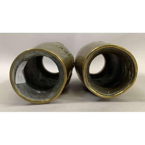 57 - A pair of Japanese brass vases the bodies having moulded and etched decoration with flared rims, 15c... 
