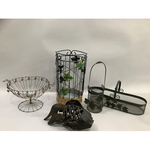 119 - A cast iron pierced fish shaped tea light holder, various wire baskets and plant holders