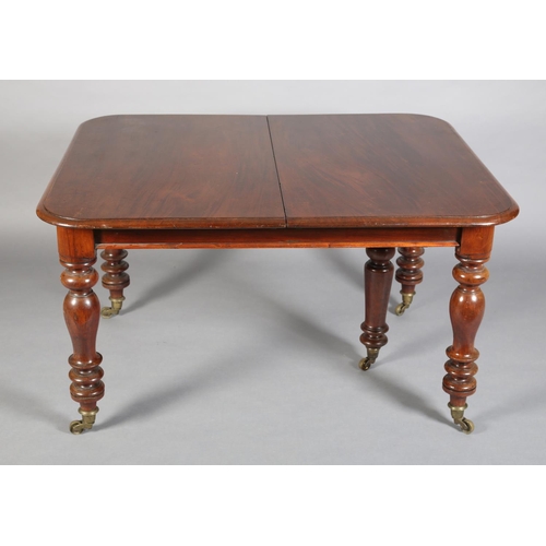 371 - A VICTORIAN MAHOGANY EXTENDING DINING TABLE, to seat eight, moulded rim, on turned legs with brass c... 