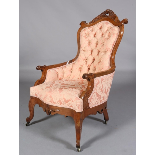 407 - A 19TH CENTURY WALNUT ARMCHAIR, having an encircling frame with pierced and carved foliate cresting ... 