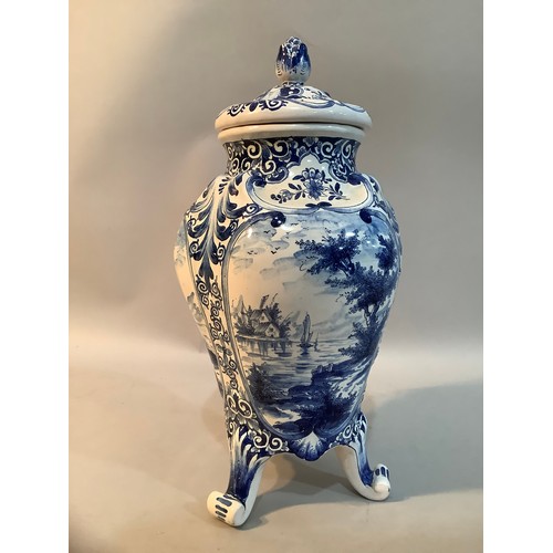 29 - A 20th Century Delft ware blue and white vase and domed cover with flower bud finial, the body paint... 