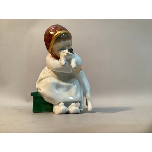 33 - A Meissen porcelain figure after Konrad Hentschel of a girl sat on green box with a cat in her arms,... 