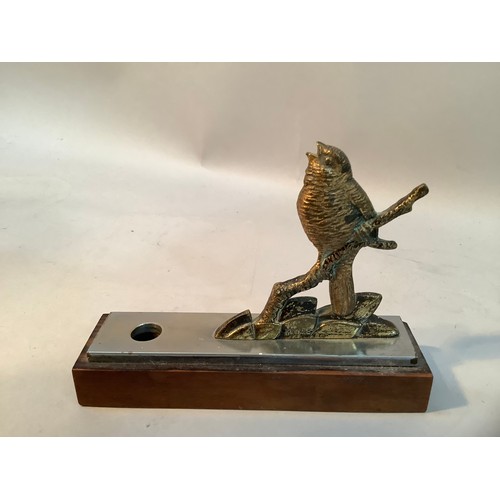 43 - A pen holder fashioned as a gilt bronze figure of a bird perched on a branch,  mounted on a steel an... 