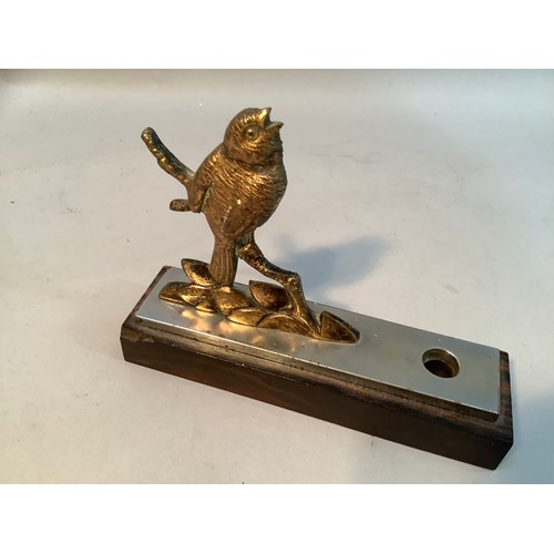 43 - A pen holder fashioned as a gilt bronze figure of a bird perched on a branch,  mounted on a steel an... 