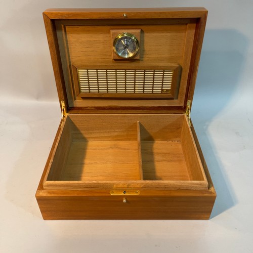 64 - A Hillwood walnut and ebonised laquered humidor, 30cm wide