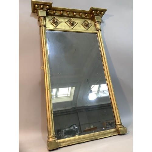 140 - An early 19th century style gilded wall mirror, the frieze moulded in high relief with three lion ma... 