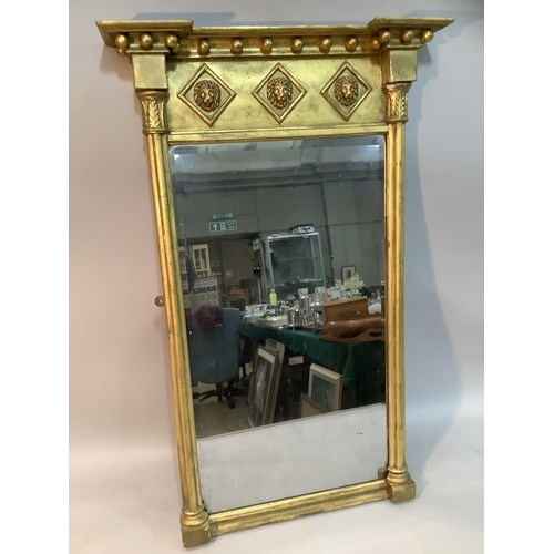 140 - An early 19th century style gilded wall mirror, the frieze moulded in high relief with three lion ma... 