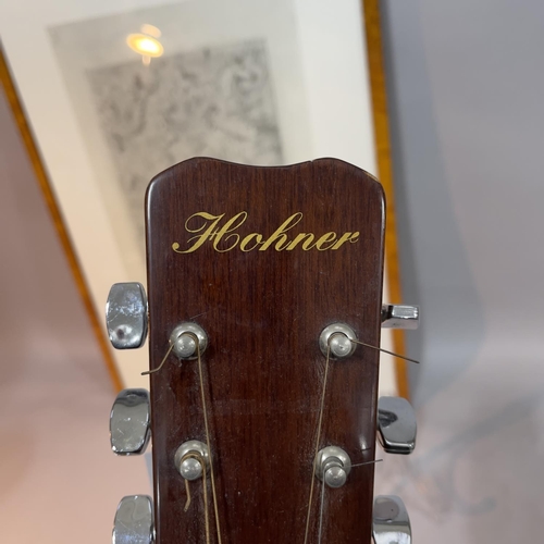 150 - A Hohner acoustic guitar together with a Disegno Italiano poster, Giorgio de Chirco, 1939, in walnut... 