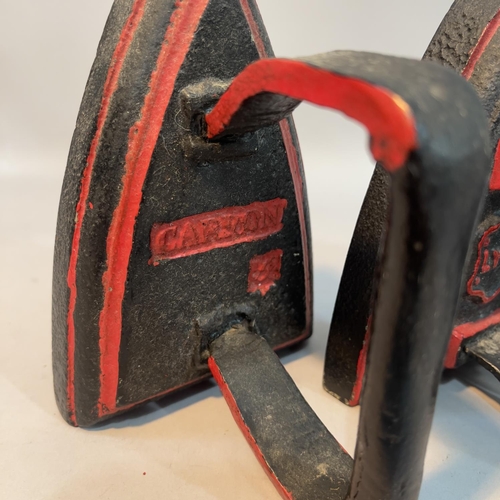 190 - Three flat irons painted in black and red, one by Carron No.5, a Lyn WC3 and another numbered 4 toge... 