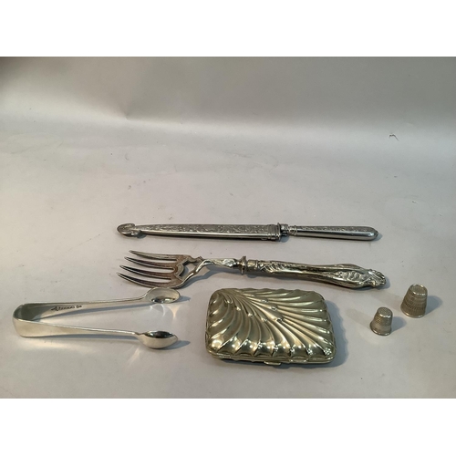 242 - A white metal handled knife and sheath 25cm long, a silver-plated bread fork, sugar tongs, cigarette... 