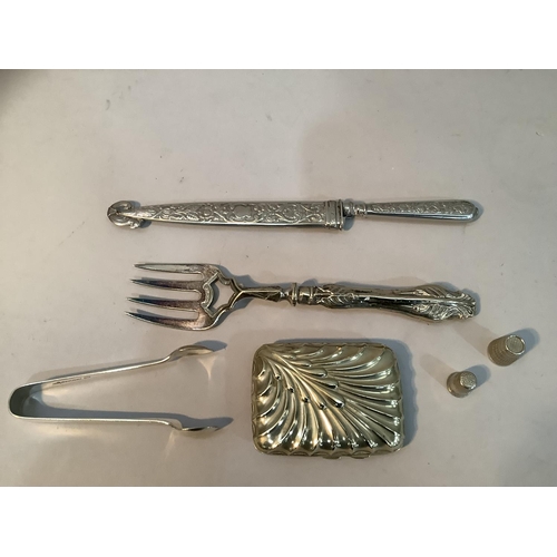 242 - A white metal handled knife and sheath 25cm long, a silver-plated bread fork, sugar tongs, cigarette... 