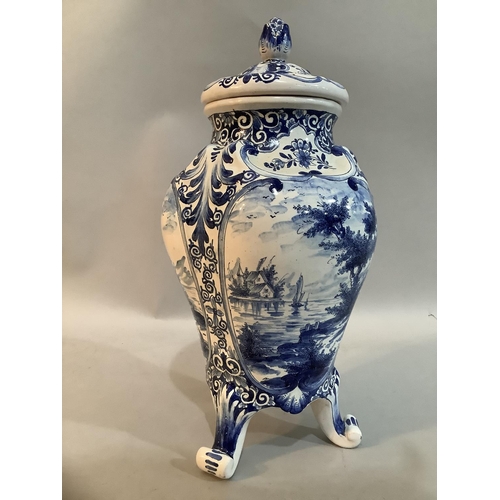 29 - A 20th Century Delft ware blue and white vase and domed cover with flower bud finial, the body paint... 