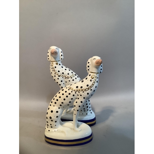35 - A pair of Sutherland bone china dalmatians in the style of Staffordshire, 19.5 x 17cm