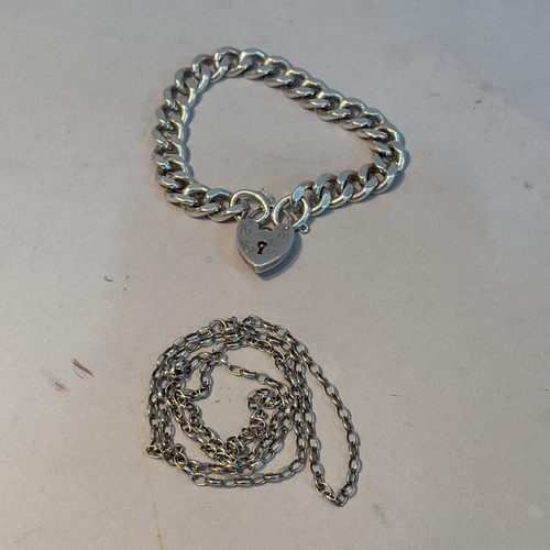 351 - A facetted curb link bracelet in silver with padlock fastener together with a silver belcher chain, ... 