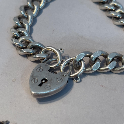 351 - A facetted curb link bracelet in silver with padlock fastener together with a silver belcher chain, ... 