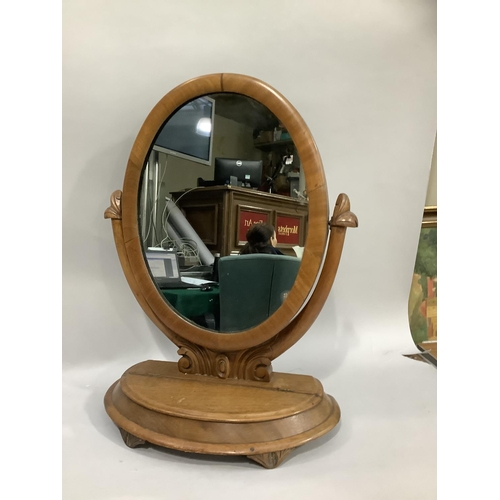 367 - A Victorian mahogany toilet mirror having an oval plate, the base with hinged lid