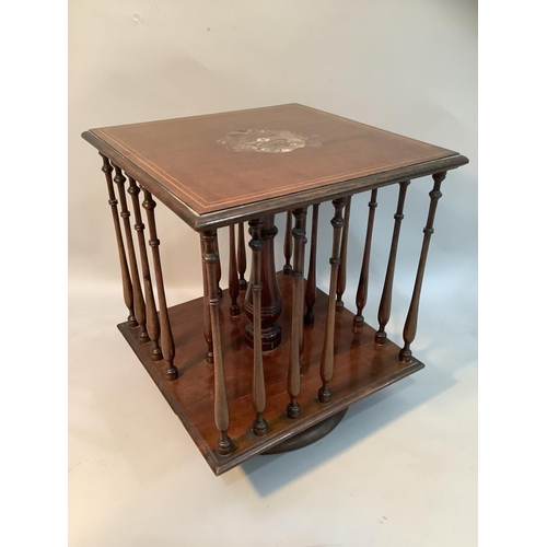 368 - An Edwardian mahogany table top revolving book stand of square outline with slender ring turned spin... 