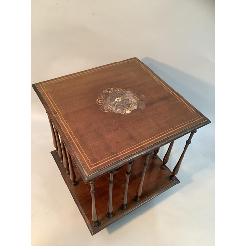 368 - An Edwardian mahogany table top revolving book stand of square outline with slender ring turned spin... 