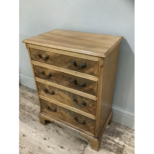 372 - A reproduction mahogany chest of four graduated drawers with swing handles and on shaped bracket fee... 