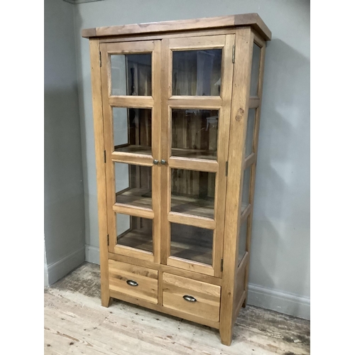 374 - A good quality oak and glazed display cabinet having a pair of eight panelled doors and conforming s... 