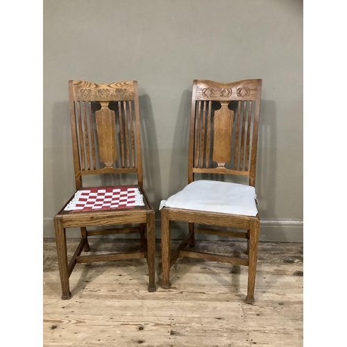 378 - A pair of arts and crafts oak single chairs having a splat and railed back and on square framing