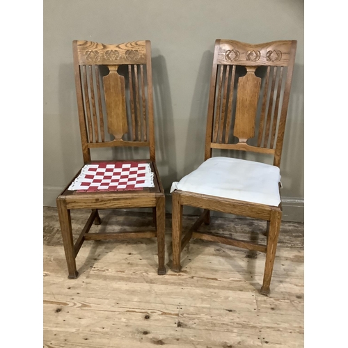 378 - A pair of arts and crafts oak single chairs having a splat and railed back and on square framing